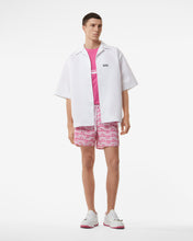 Load image into Gallery viewer, All-Over Waved Logo Print Swim Shorts | Men Swimwear Fuchsia | GCDS Spring/Summer 2023
